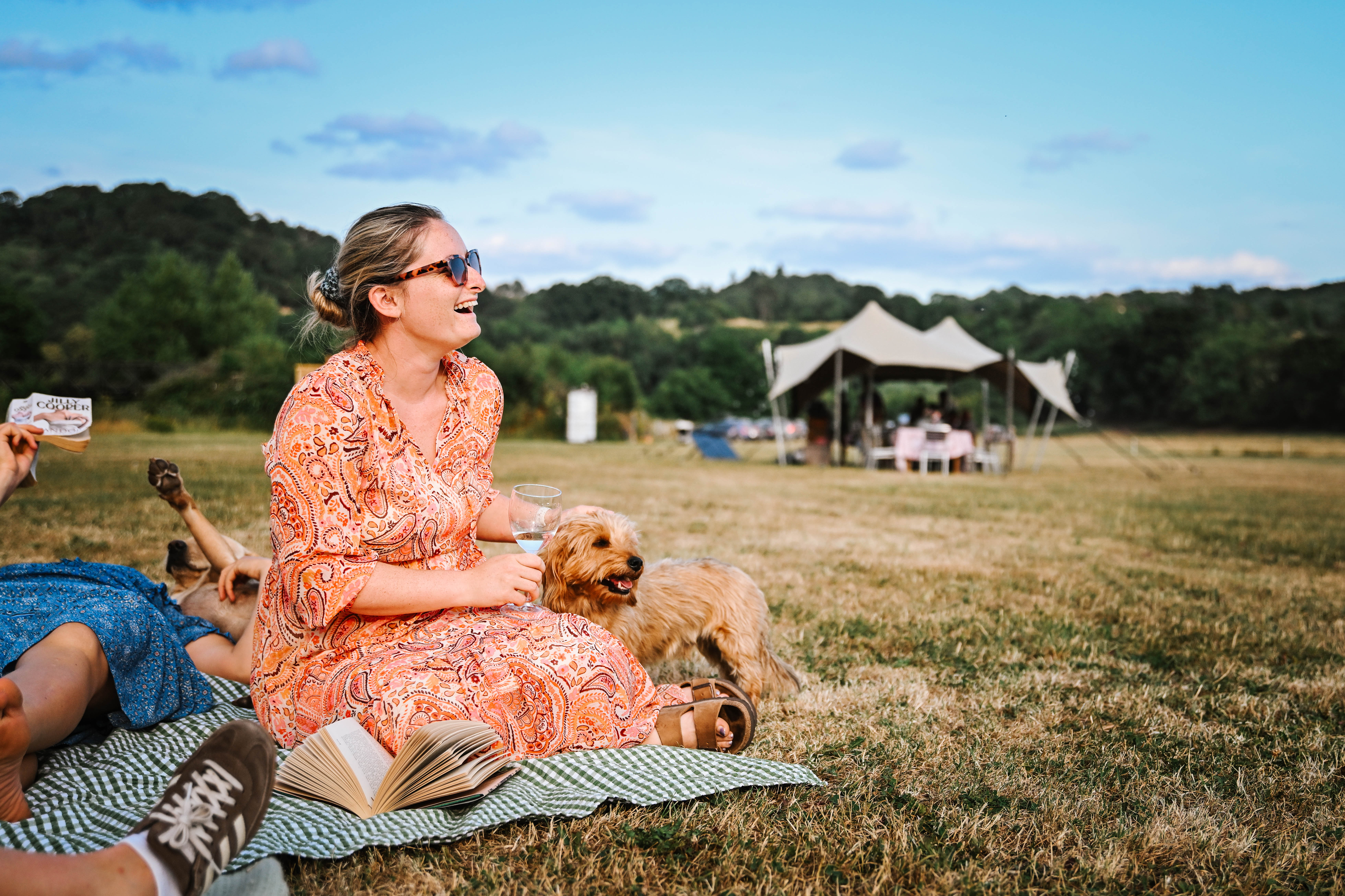 Guests reading in a bell tent at Hopnest Retreats